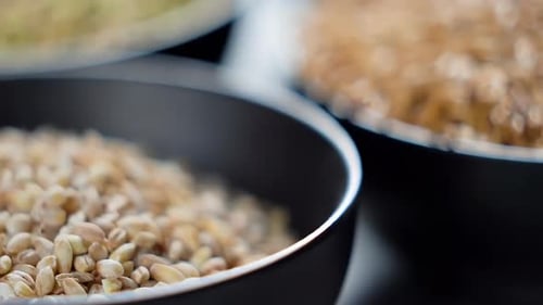 Close Up View of Barley Grains in Black Bowls