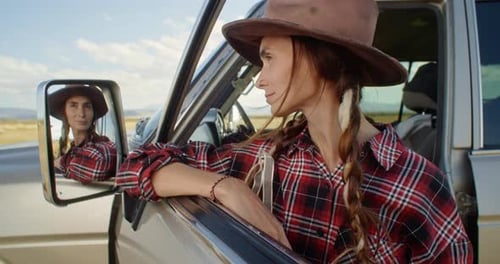 Woman Enjoying Desert View from Car Window