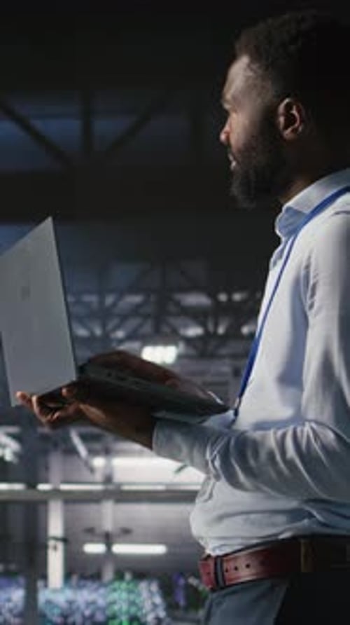 Vertical Video Technicians on Data Center Industrial Platform Analyzing Performance Outputs