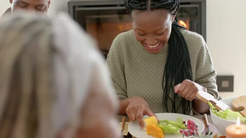 Adults Laughing Together Around Dinner Table with Food