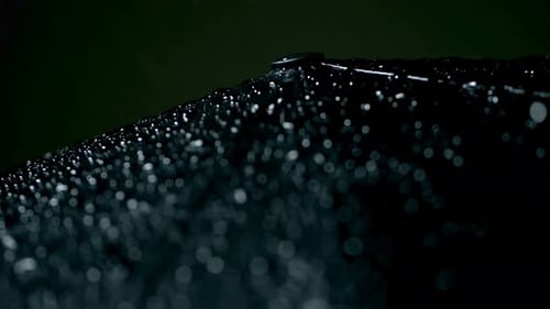 Macro Shot of Raindrops on a Dark Fabric