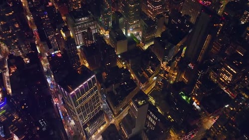 Flying high above the lively traffic streets at night time. Splendid Manhattan architecture