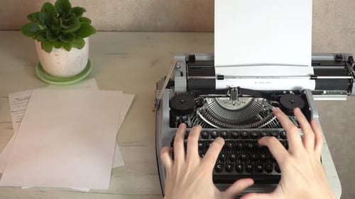 Writing a book and typing old typewriter, top view. Man typing on old vintage retro typewriter