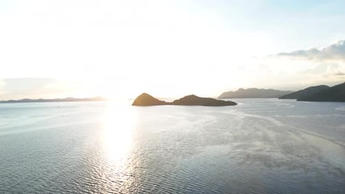 Beautiful island bathed in warm sunset light, with the sky glowing in vibrant colors.