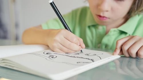 Child Hand Drawing with Colorful Markers in Sketchbook Creative Process
