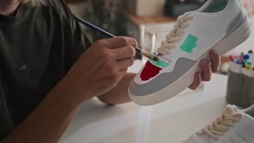 Person Customizing White Sneaker with Colorful Paint