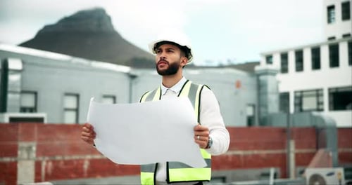 Engineer Holds Plan on Construction Site