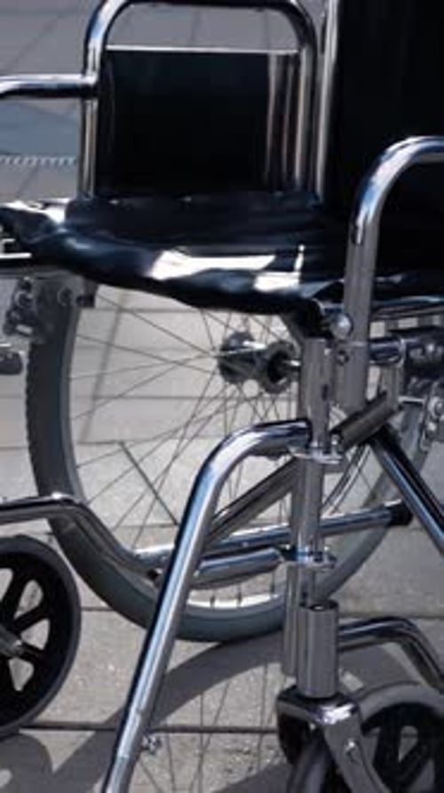 Vertical of Disables Wheelchair Rolling Near Modern Business District