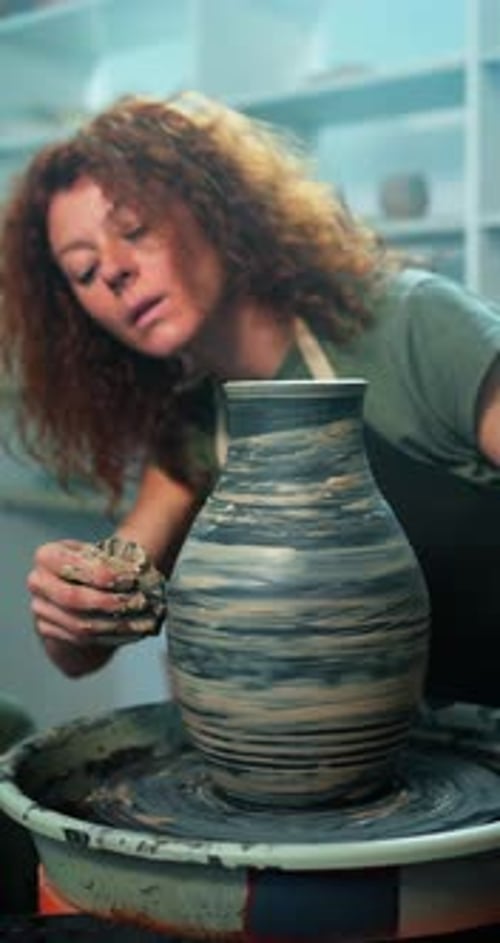 Woman Shaping Clay Vase on Pottery Wheel