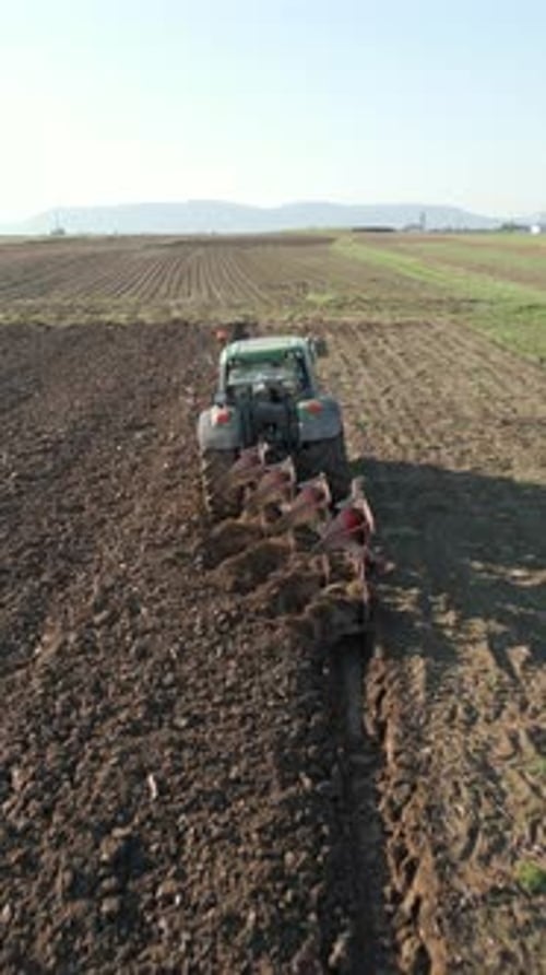 Tractor Plows Land In The Field Aerial