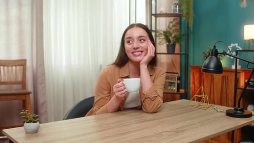 Woman Drinking Coffee and Relaxing in Living Room