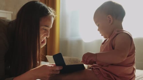 Mother and Baby Reading a Book Together