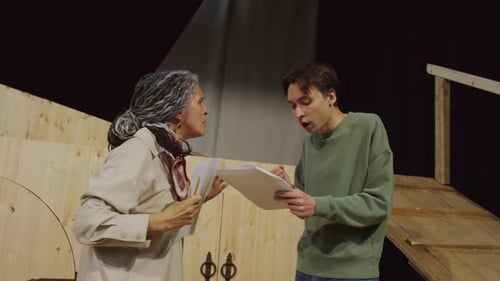 Mature Female Theatre Director Teaching Young Actor How to Perform Dialogue