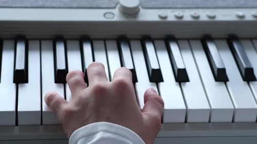 Kid Fingers on Digital Piano Key Little Girl Practicing Music