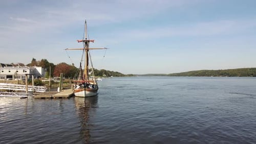 Aerial low level push forward shot of the Pinnace Virginia boat on the River Kennebec