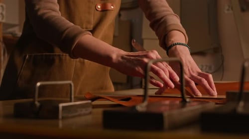 Concentrated Craftswoman at Work in Leather Workshop