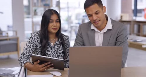 Two Young Adults Collaborating in Modern Office