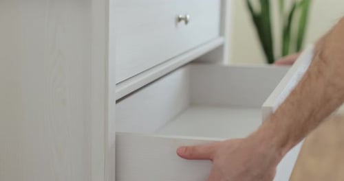 Handyman Installing and Adjusting Drawer Slide Mechanism in Contemporary Kitchen Furniture