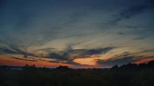 Fiery Sunset Sky over Silhouetted Trees