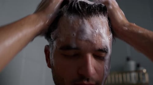 Man Washing Hair with Shampoo in Shower