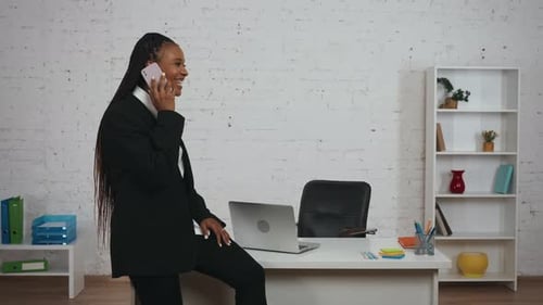 Professional Woman Talking on Phone in Modern Office