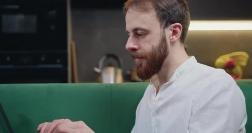 Man Working on Laptop at Home