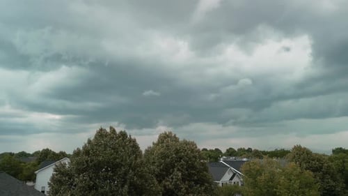 Stormy Clouds Forming on Gloomy Sky Before Heavy Rainfall and Lightning Over Suburban Town City