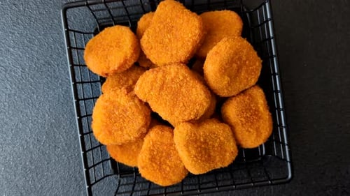 Fried chicken nuggets with sauce, salt, and spices, fast food, unhealthy food. Chicken nuggets
