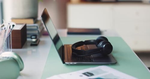 Break, headphones and laptop on desk in home office for planning, remote work or research