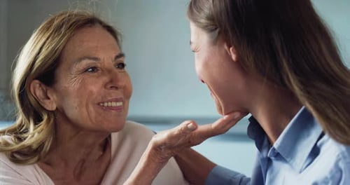 Affectionate Moment Between an Adult Woman and Senior Woman