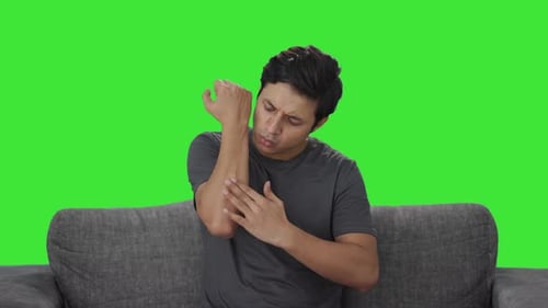 Indian man putting bandage on wound Green screen