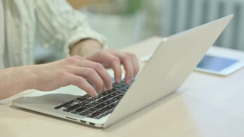 Close up of Male Hands Typing on Laptop