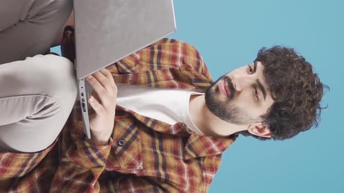 Young Adult Typing on Laptop in Vertical Video