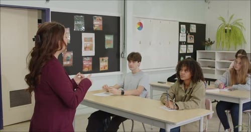 Students Learning in School Class Room. High School or College Class Raising Hand Asking Questions