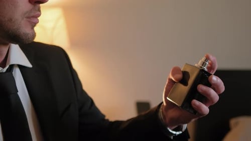 Close Up Shot of Man Splits the Perfume on Himself Slow Motion