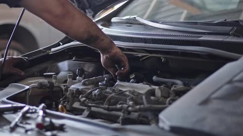 Car Engine Repair With Socket Wrench In The Repair Shop