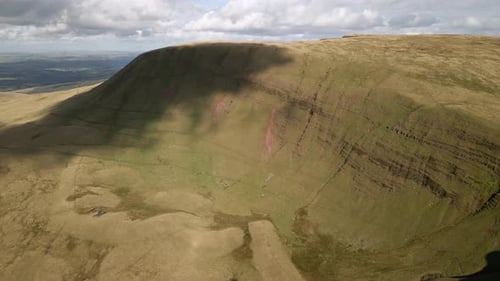Cloudy shadows passing over Llyn y fan Fach Brecon beacons green mountain wilderness countryside aer