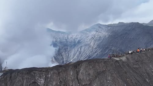 aerial view flying to mount Bromo active volcano above sea of clouds, Java, Indonesia