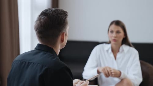 Indoor Conversation Between Man and Woman in Office