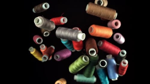 Multicolored Threads Fly on a Black Background Filmed on a Highspeed Camera at 1000 Fps