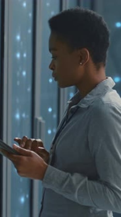 Woman Using Mobile Phone in Data Center