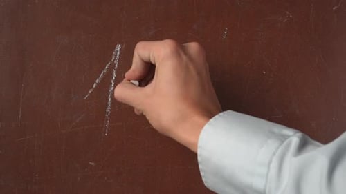 Hand Writing Equation on Chalkboard