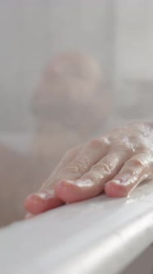 Man Relaxing in a Steamy Bathtub, Close Up
