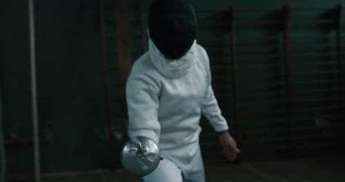 Cinematic slow motion shot of two professional young people is practising assaults of fencing with