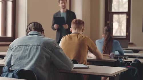 Teacher Lecturing to Students in Classroom Setting