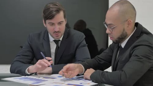 Two Men Collaborating on Business at Workplace