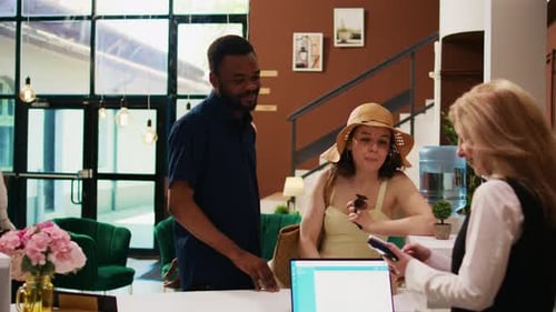 Tourists Paying for Room Reservation