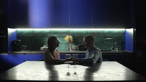Couple Enjoying Romantic Wine Night in Modern Kitchen
