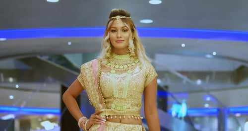 East indian girl in traditional indian wear walking in a mall