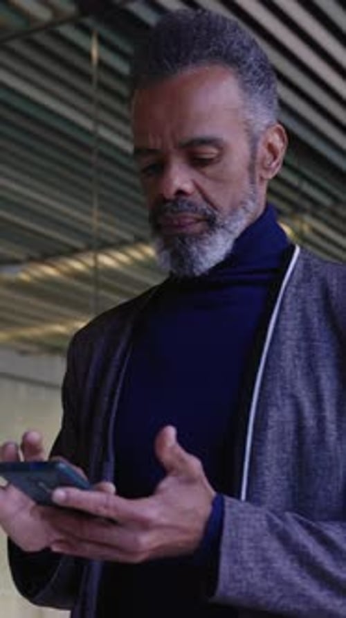 Man Using Smartphone in Modern Urban Setting